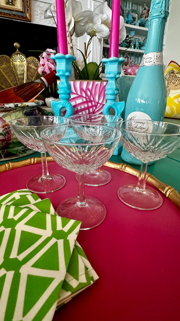 Vintage Crystal Champagne Coupes styled on a pink tray with cocktail napkins