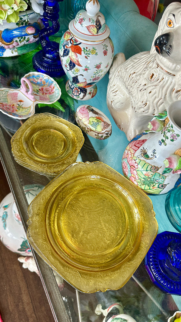 Vintage Depression Glass Plates in yellow displayed in stacks of 7 on a styled table