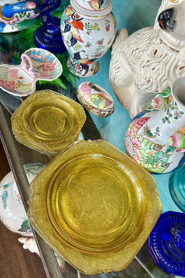 Vintage Depression Glass Plates in yellow displayed in stacks of 7 on a styled table