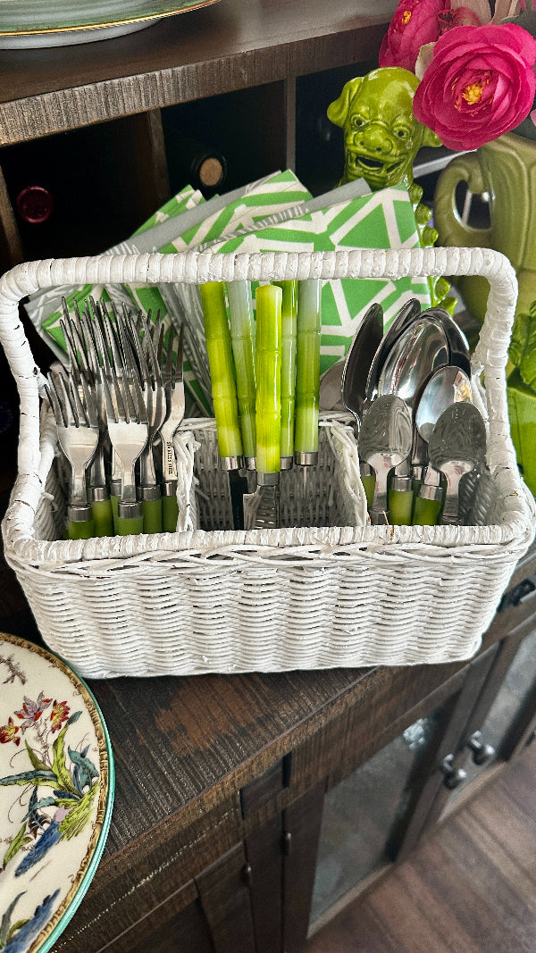 Vintage Wicker Storage Basket- Silverware in white with a handle filled with silverware and napkins in separate compartments styled on a serving bar