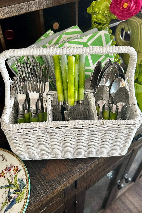 Vintage Wicker Storage Basket- Silverware in white with a handle filled with silverware and napkins in separate compartments styled on a serving bar