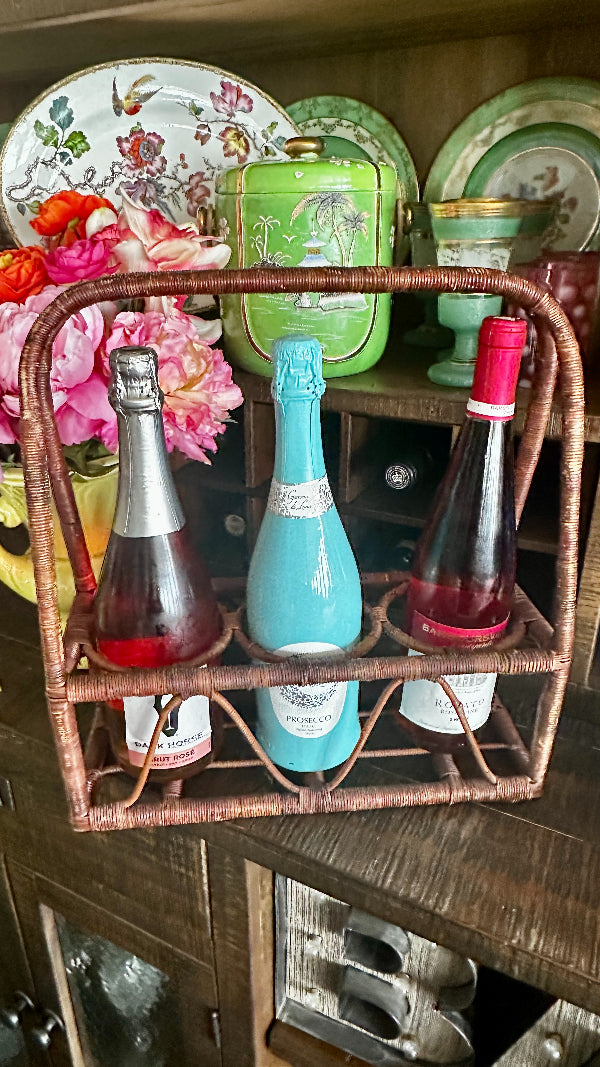 Vintage Wine Caddy - Wicker in brown with 3 separate compartments holding 3 different sized bottles. Styled on a bar.
