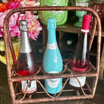 Vintage Wine Caddy - Wicker in brown with 3 separate compartments holding 3 different sized bottles. Styled on a bar.