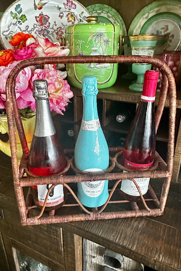 Vintage Wine Caddy - Wicker in brown with 3 separate compartments holding 3 different sized bottles. Styled on a bar.
