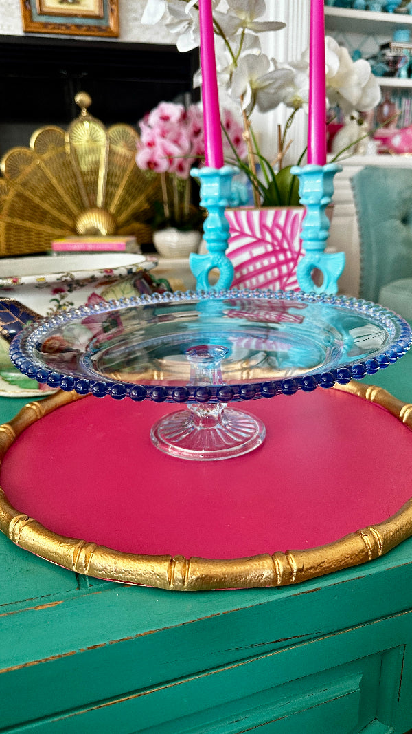 hobnail blue glass cake stand styled on a colorful table