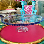 hobnail blue glass cake stand styled on a colorful table